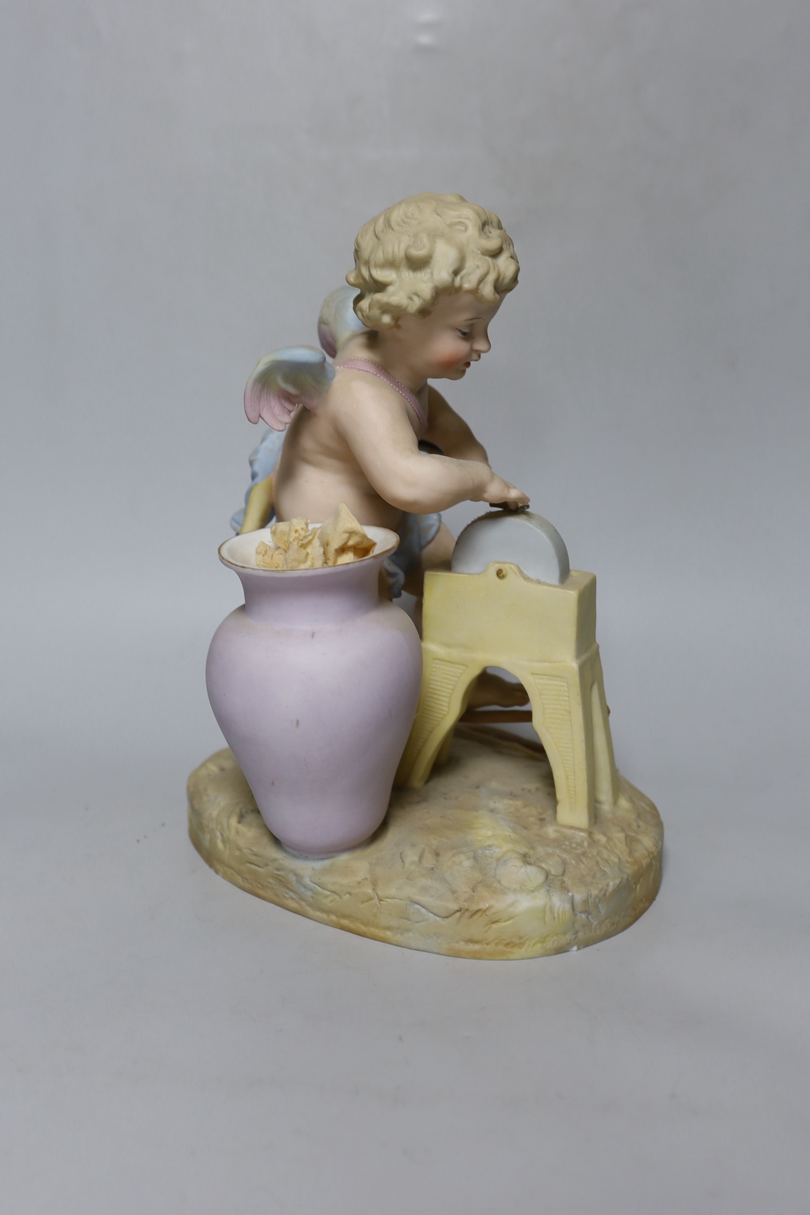 A continental bisque porcelain figure group, Cupid at work, 27cm